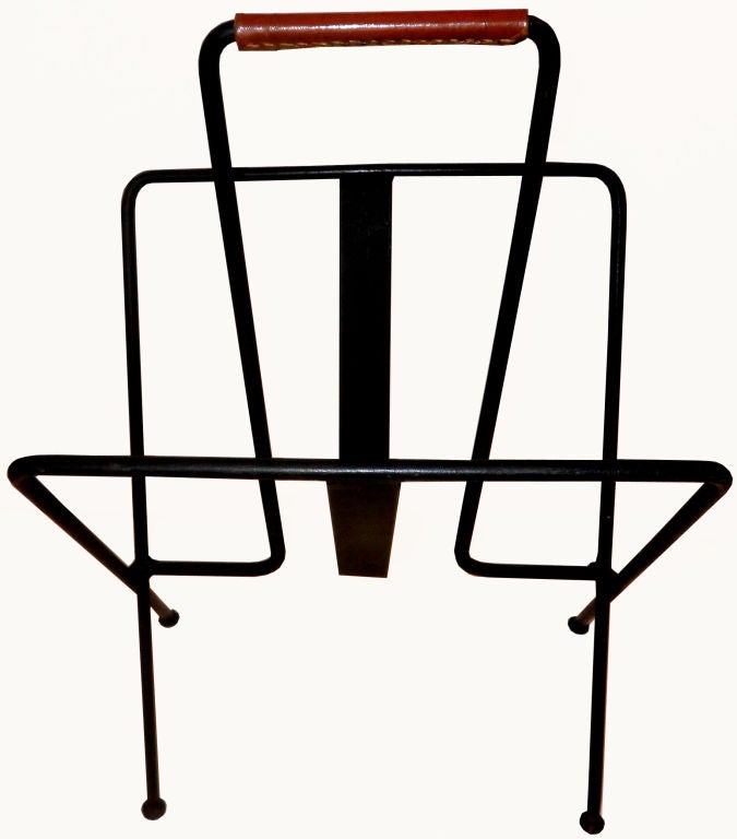 A classic Magazine Rack or Newspaper Stand by JACQUES ADNET, France. 
Painted black iron Frame and Hermes Leather Handle.
French superb Mid-Century Modern Icon.
