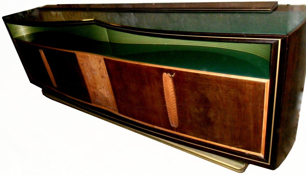 Vittorio DASSI long credenza, buffet, sideboard with 4 doors made in the 1960s.
Sycamore & Walnut with beveled, reversed painted green glass tops and gilded wood base.
In good original condition Brass ornaments on the doors and key included.
 