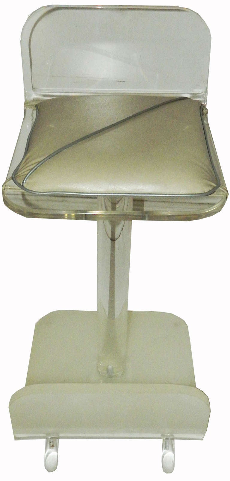 Pair of lucite stool  in the style of Karl Springer .
Swiveling seats, original seat pads.