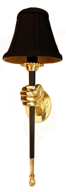 French wall sconces two patinas brass and bronze by Maison Jansen, featuring hand holding a torch. Priced by pair.

Measurements: with shade: 17" H, 6" W, 7.5"
 without shade : 14" H, 3" W, 6" projection to the