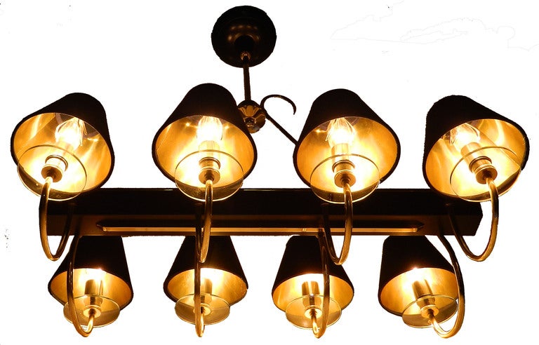 Two-tone (brass and gun metal) eight lights French chandelier with circular glass bobeches.