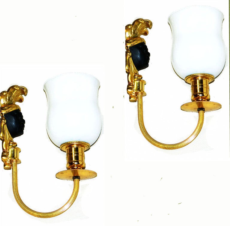 Pair of very elegant sconces, Wall Lights made out of Bronze Head with black finish and Original Opaline Shades.
One pair in silver available.
Measurements: 8.5 inches H, 6 inches D projection from the wall, 3.5 inches W.
US rewired and each Sconce