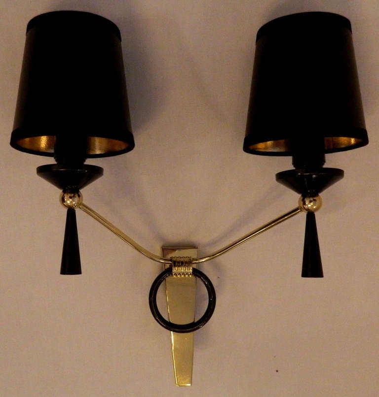  Pair  of Jacques Adnet sconces. Two patinas gun metal and brass.
80w/ each bulb.
Price for one pair.
Projection to the wall 6