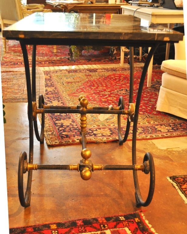 Wonderful iron and bronze and brass legs and dramatic black marble with gold veining.