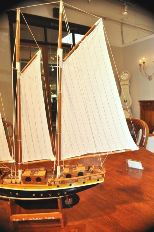 Custom Sailboat made on the Island of Bequia by Augustine Pollard who was patronized by Elizabeth II, the Queen of England. Intricate and detailed work. It comes with a stand.