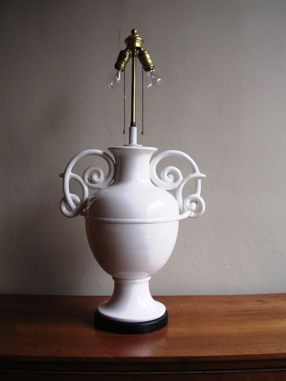 a classic large double handled white glazed Egyptian style lamp base after Giacometti favored by Jean-Michel Frank, Syrie Maugham and Frances Elkins. shade not included<br />
oah 36