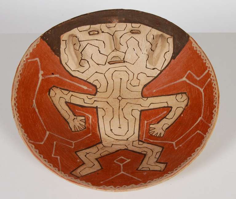 A large Impressive Shipibo pottery bowl from the Peruvian Amazon. Nicely decorated with a figure with raised facial features and underside of complex geometric designs typical of the period. Overall in excellent condition. Coated on underside with a