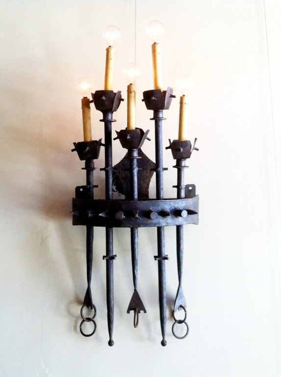 An amazing set of four brutalist style hand crafted iron five light wall sconces
