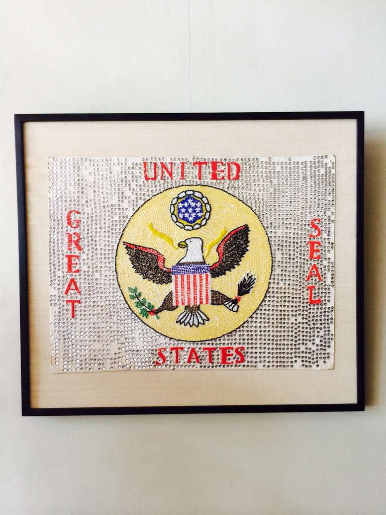 An as found framed patriotic folk art cardboard sign applied with beads and sequins depicting the Great Seal of the United States