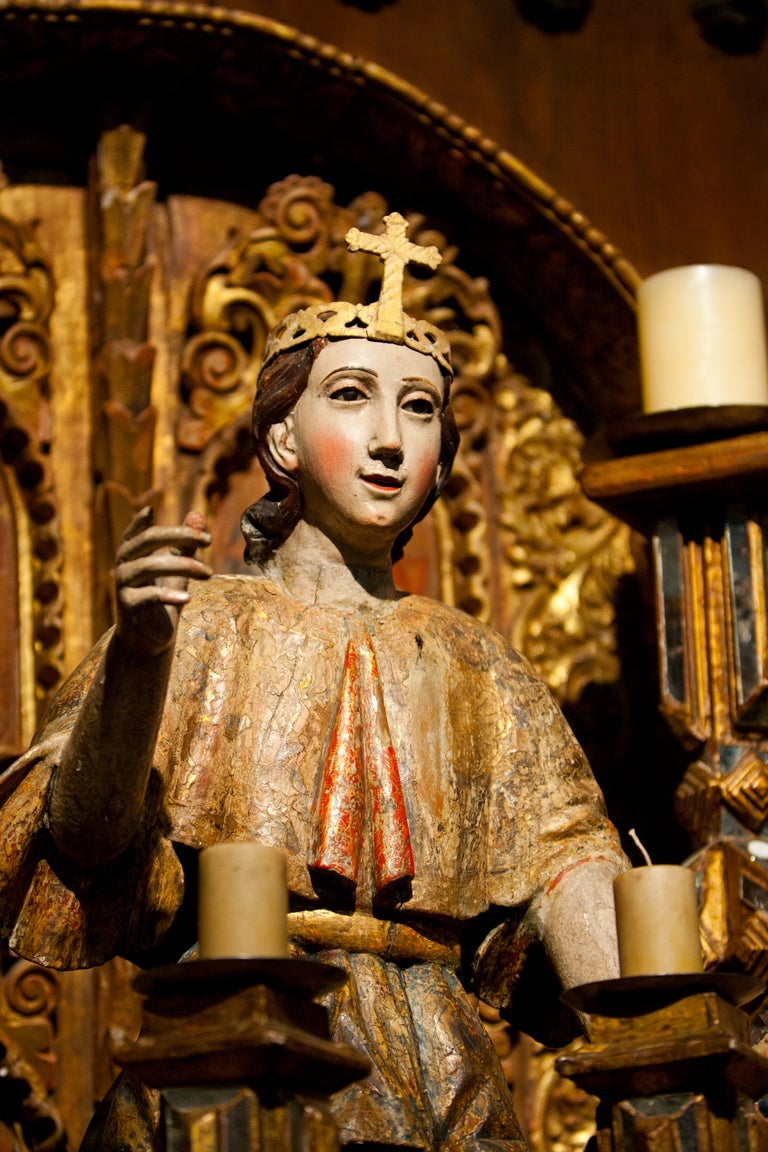 18th Century polychrome and gilt wooden archangel with leather crown.