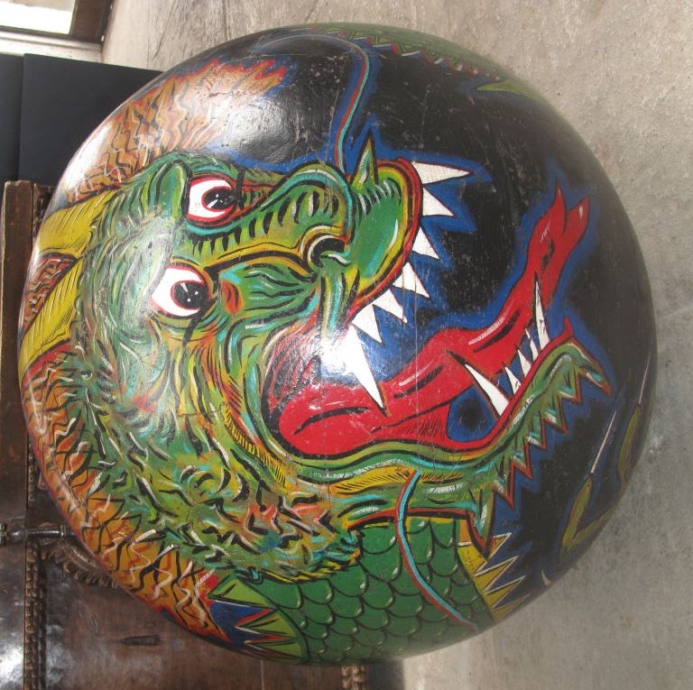 Dragon painted on wooden sphere.<br />
Can be put on top of table, armoire, etc.