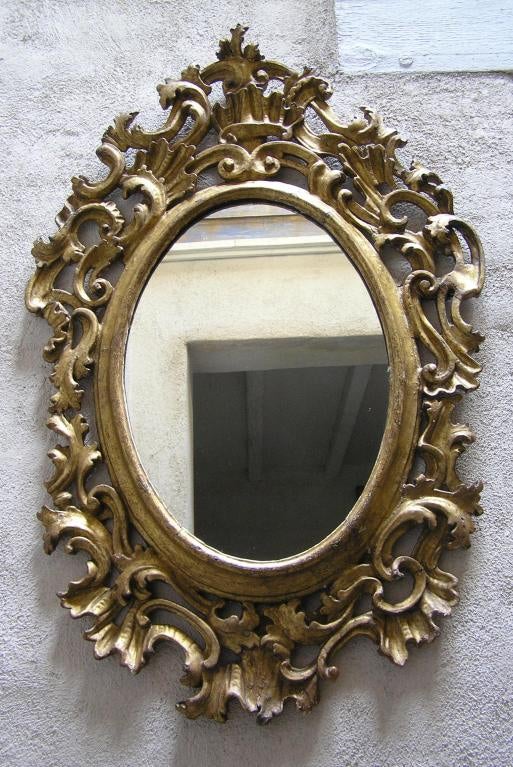 XVIII century Spanish colonial gilt wooden frame with new mirror.
Have many more in different styles, shapes and dimensions in our inventory.