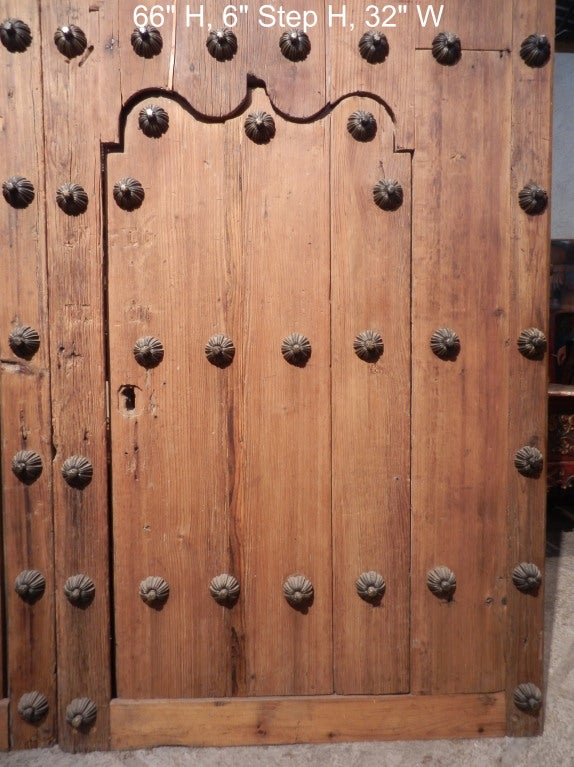 Pair of large hacienda doors with smaller doors insets.  Original hinging and most nails.