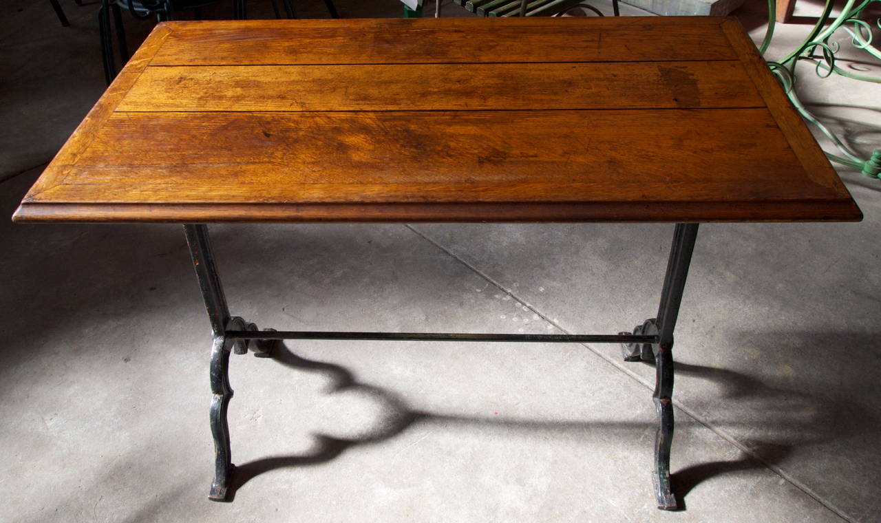 Oak wood top on painted cast iron base late 19th/early 20th century French bistro table with nice patina