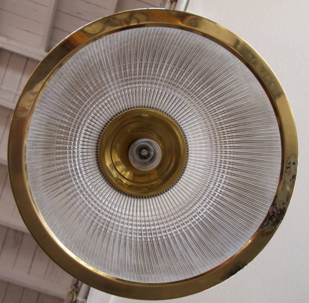 Large hanging Holophane glass and heavy brass dome shaped Industrial pendant light fixture from the mid-2Oth century.