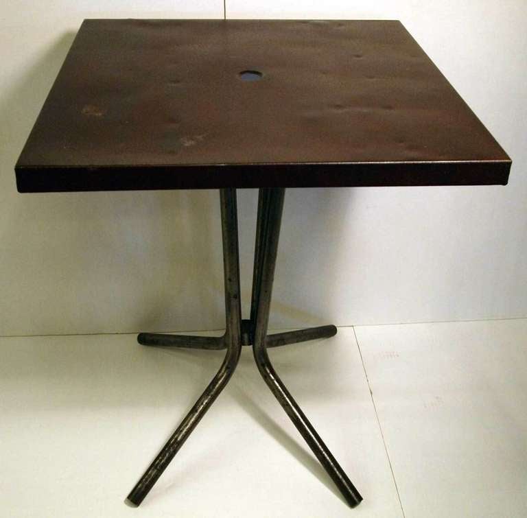 Metal bistro table with square top on 4 leg tube metal base with nice patina