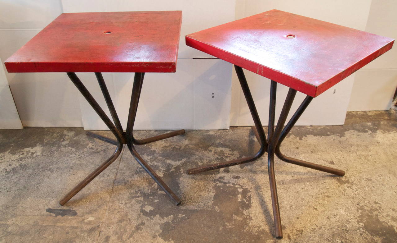 Pair of French red painted metal top on metal base mid century industrial square bistro tables