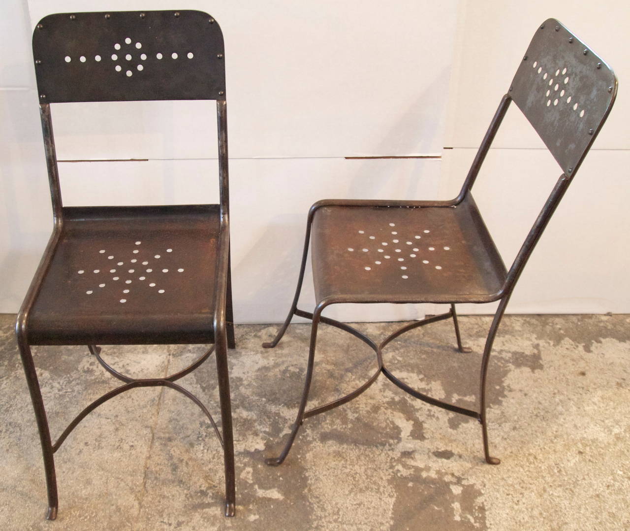 Wonderful pair of French industrial metal garden side chairs from the early 20th C. with beautiful patina