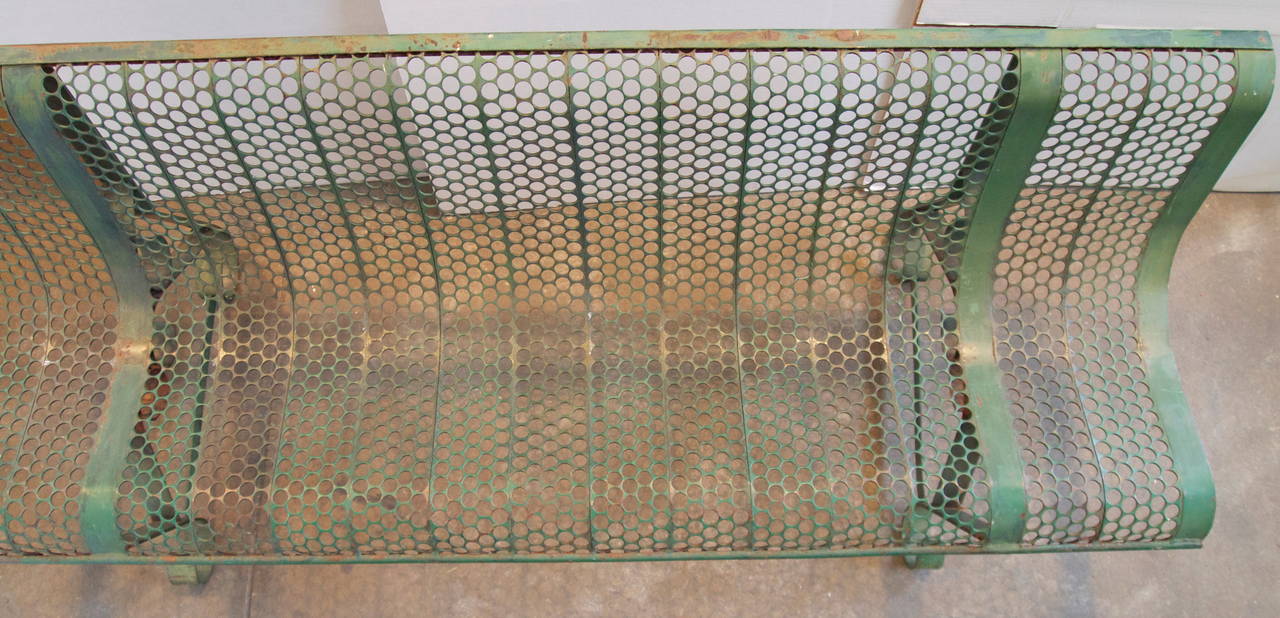 Mid-Century Modern French perforated steel green painted garden bench with elegant lines and styling.