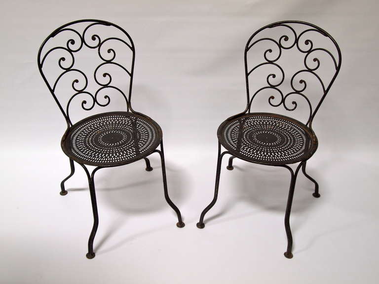 Pair of French black painted wrought iron garden chairs