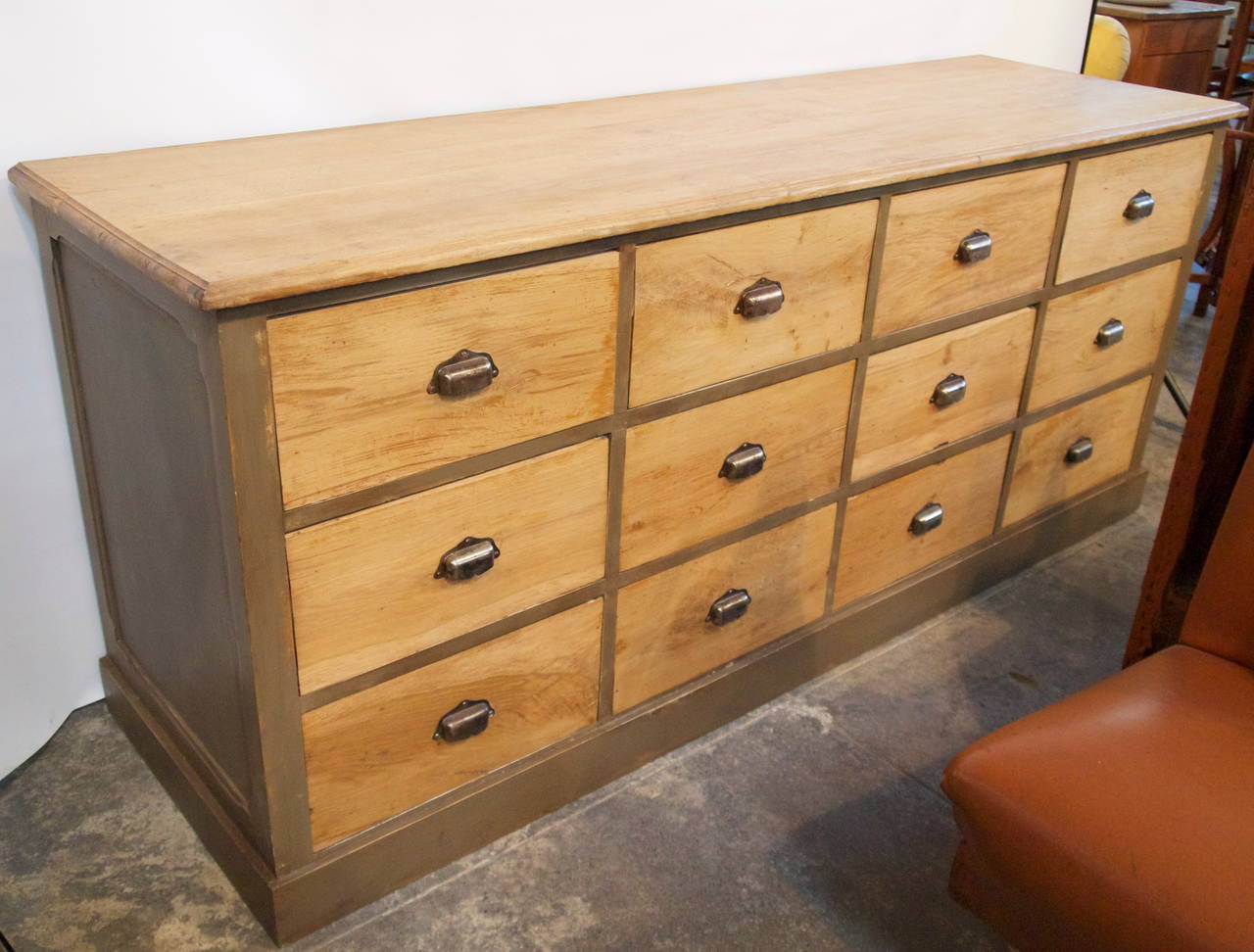 Handsome and well proportioned mellow oak wood and grey painted 12 drawer French merchants counter with original hardware pulls