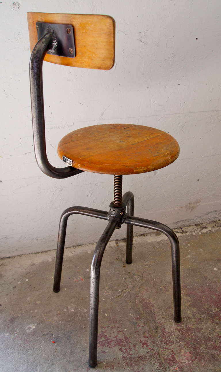 Industrial metal and stained wood school chair with adjustable height swivel top seat.