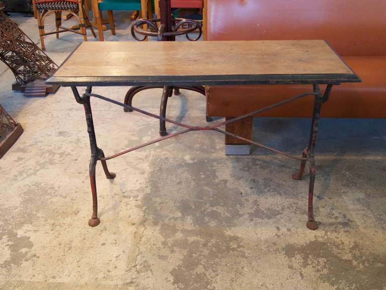 French Oak wood top bistro table on painted iron base with nice patina.