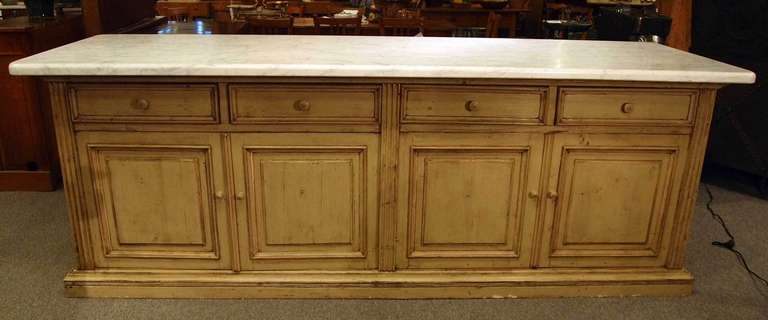 Large French merchants storage counter with (1.5 inch) thick white marble top.  Painted base finished on all sides with 4 drawers and 2 storage spaces & shelves.  Attractive display unit with excellent working height and function.
Saint Remy de