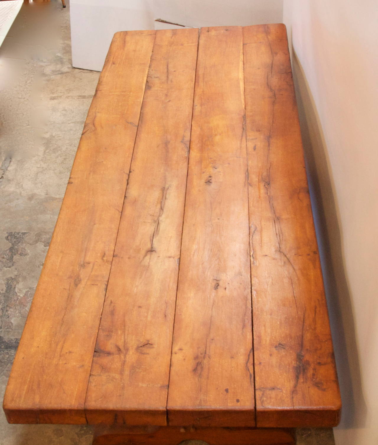 Large and impressive French chestnut Rustic farmhouse trestle table with thick four plank top. Through tenon, wedge mortises on each end, and the top is removable for transportation or installation.