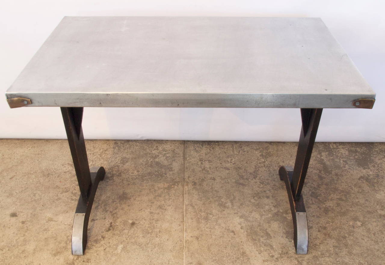 Heavy zinc and brass banded top French bistro table, with metal toe caps from the early 20th century