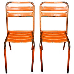 French industrial orange painted metal bistro chairs