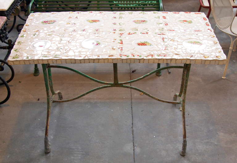 French 19th century painted cast iron garden table with a later decorative broken plate top