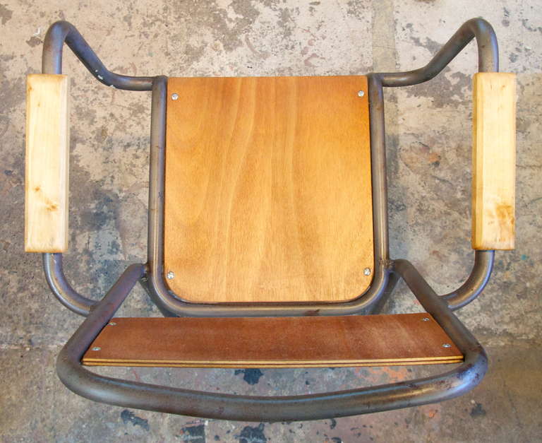 Set of 12 mid century metal and stained wood stack-able industrial armchairs.