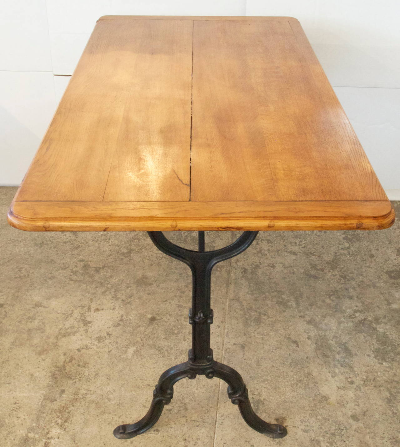 French oak wood top rectangular bistro table on a cast iron base with nice patina,  from the early 20th century.