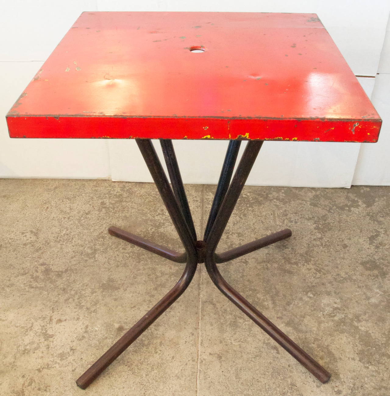 French Mid-Century/Modern red painted square metal top on a black painted tube metal four leg base bistro/garden table.