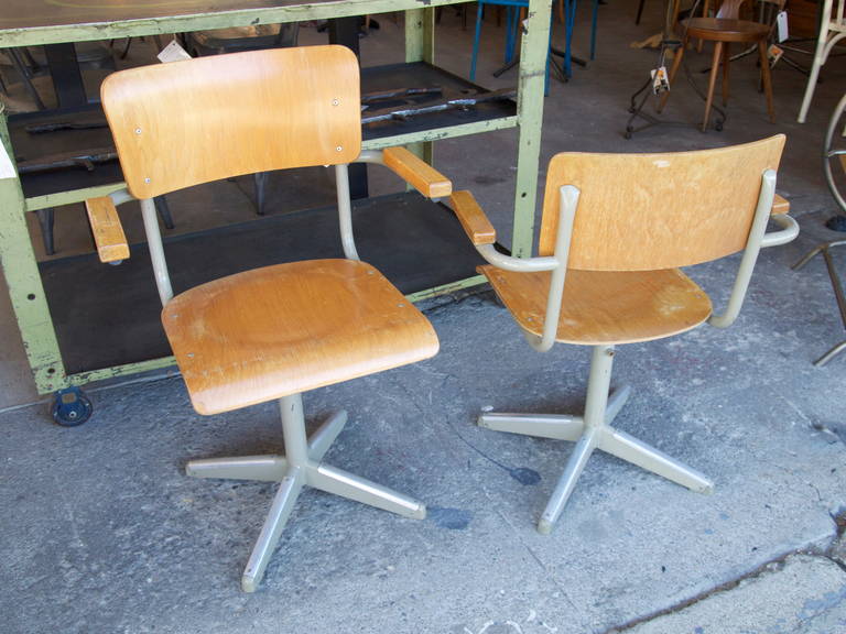 Set of eight French industrial midcentury height adjustable armchairs made of formed plywood and metal.