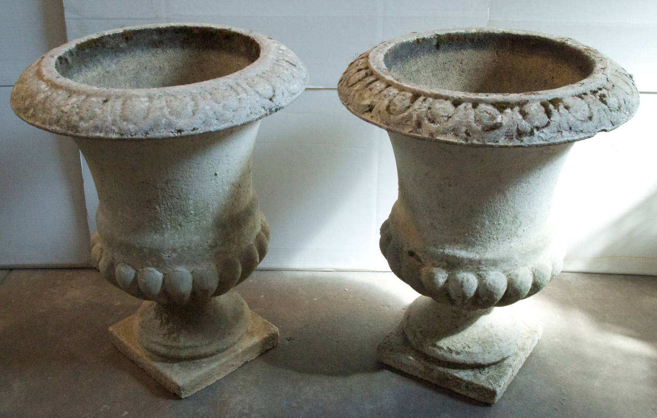 Impressive pair of large French garden cast stone campana urns from the late 19th-early 20th century.