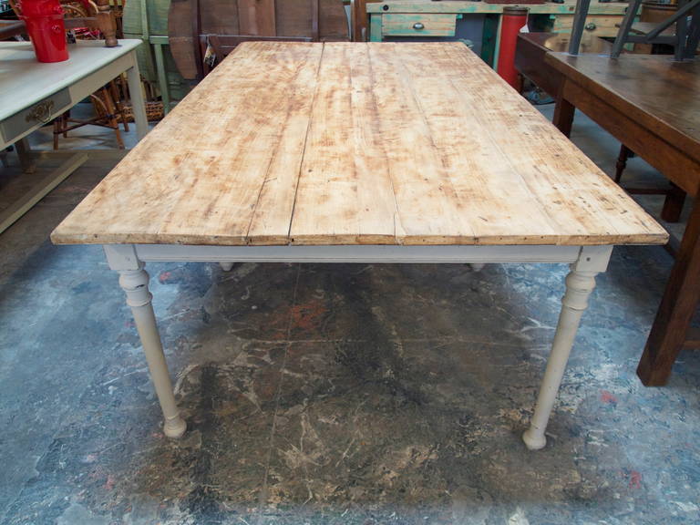 Large and wide farm table with stained wood top on a 6 leg grey painted base
20th C.
France