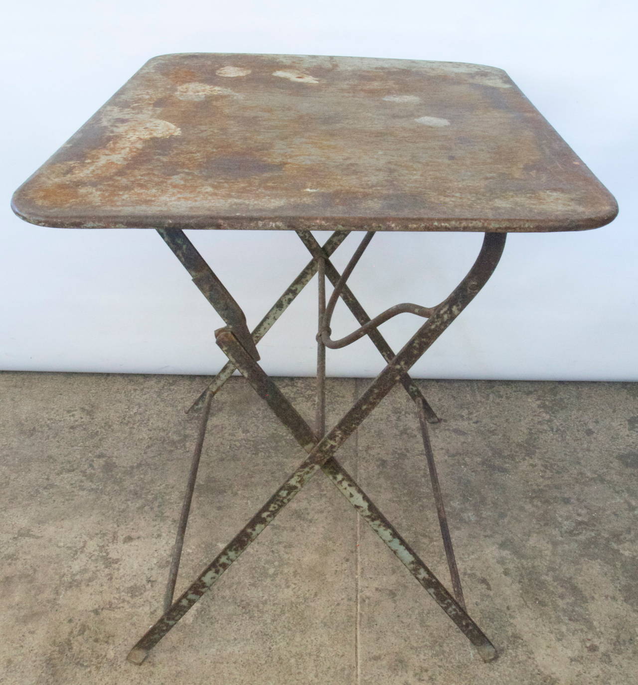 Late 19th-early 20th century French rectangular metal top on folding metal base garden table with nice character and patina.