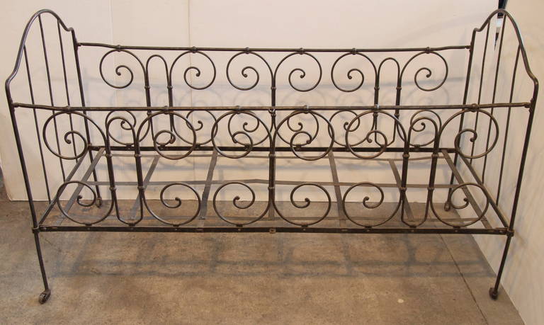 Unusual and decorative unmatched pair of wrought iron baby cribs with nice patina from the mid-19th century.