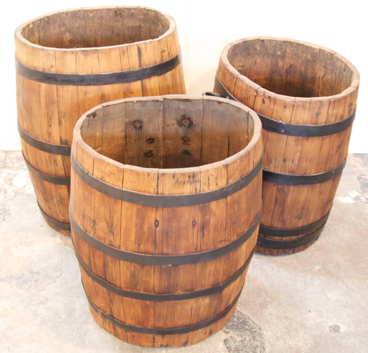 Set of 3 French winery iron banded oak wood oval grape collecting barrels with attached shoulder strap iron handles,  early 20th C.