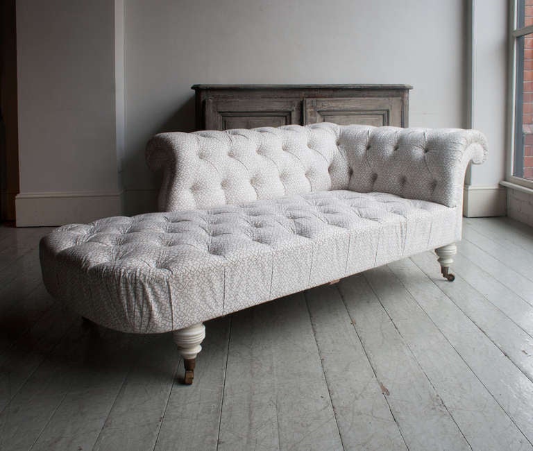 a supremely luxurious day bed/settee in a chesterfield style, traditionally upholstered with individual hand tied springs and stitched horse hair, the turned painted oak legs with custom made brass cup-castors, covered in HOWE® Lattice in 'New