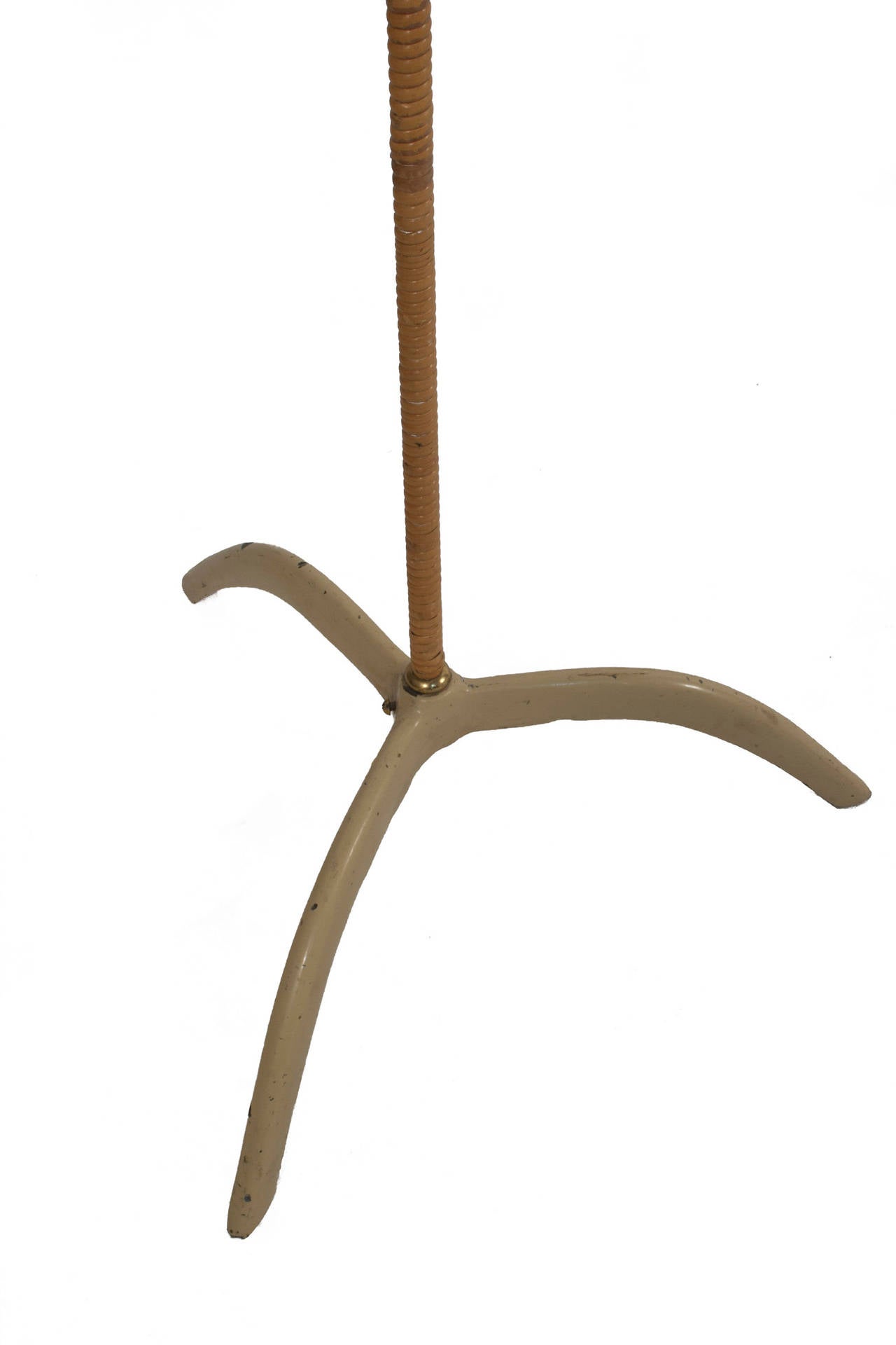 Floor lamp in brass and cane with adjustable shade by Paavo Tynell.