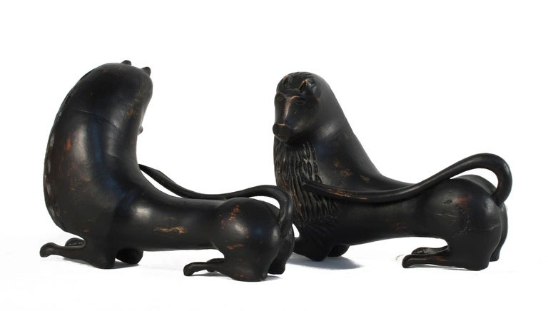 Pair of carved Empire Lions in a worn black patina.