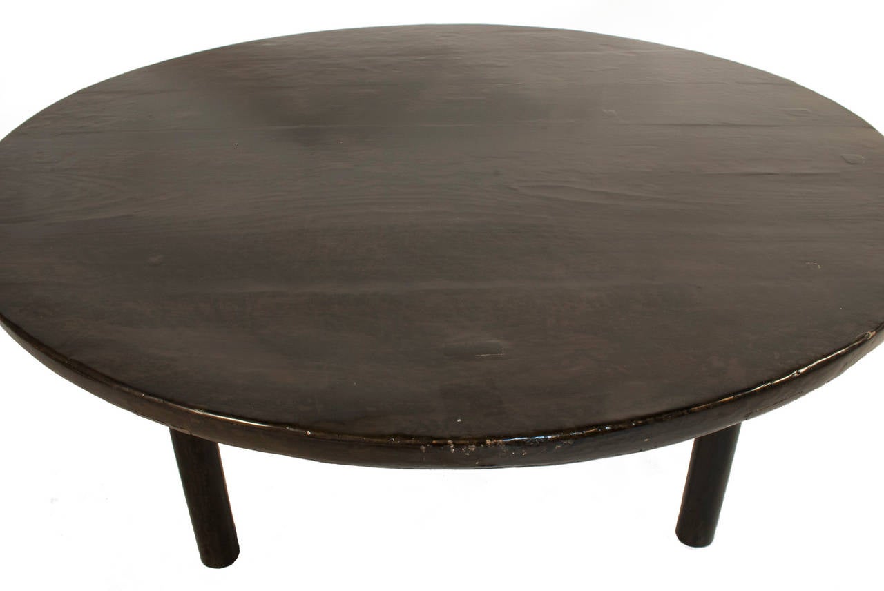 Round lacquered Coffee Table in a worn black patina.