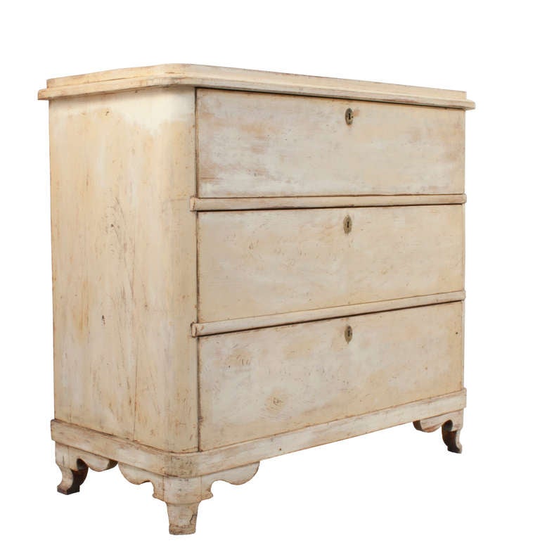 Pair of three drawer Chests in a worn pale yellow patina.