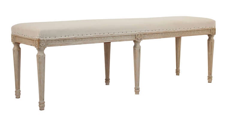 Gustavian style bench in a worn pale grey patina.