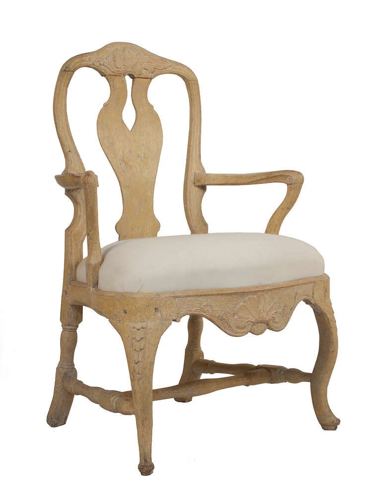 Pair of Rococo Armchairs in a worn pale yellow patina.