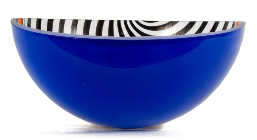 Glass Bowl with an orange line seperating a blue and a striped black half sphere.