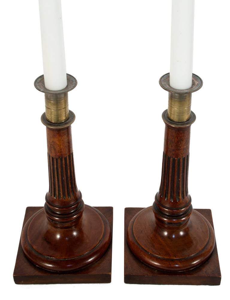 Pair of brass and mahogany candleholders.